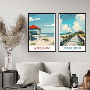 May include: Two vintage-style travel posters featuring scenic views of Tybee Island, Georgia. The left poster shows a beach with a red-roofed building and the text "Tybee Island, Georgia". The right poster shows a wooden boardwalk leading to a beach with the text "Tybee Island, Georgia".