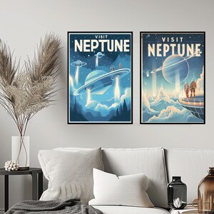 May include: Two framed art prints with a retro space travel theme. The prints feature the words "VISIT NEPTUNE" above images of flying saucers and a planet with rings. The color palette is primarily blue and white.