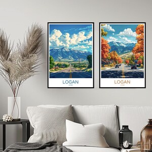 May include: Two framed prints of scenic views of Logan, Utah. The top print shows a road leading to a mountain range with a blue sky and white clouds. The bottom print shows a road lined with trees in autumn colors with a mountain range in the background.