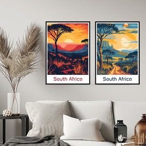 May include: Two framed prints depicting South African landscapes. The print on the left shows a sunset over a savanna with a large tree in the foreground. The print on the right shows a dirt road leading through a savanna with a large tree in the foreground.