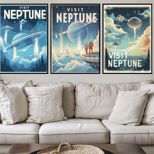 May include: Three framed art prints with a retro travel theme, each featuring a different scene of a UFO visit to Neptune. The prints have a vintage aesthetic with the words "VISIT NEPTUNE" at the top. The artwork is in shades of blue, green, and beige.