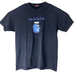 May include: Black t-shirt featuring a blue cartoon monster graphic and the text "I Have the Dark Cooties". The monster is saying "I am a cookie, I am dark".