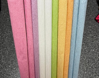 May include: Assortment of ten colorful crepe paper streamers in pink, purple, white, green, yellow, orange, and blue. The streamers are bundled together and ready for crafting or decorating.
