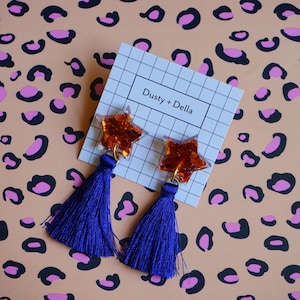 Tan orange glitter stars with blue silk tassels dangly earrings