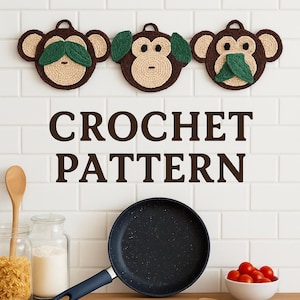 May include: Three crochet monkey face wall hangings with brown, tan, and green details. The text "CROCHET PATTERN" is displayed below the monkeys. A black frying pan, jars of pasta and flour, a bowl of tomatoes, and wooden spoons are on a wooden surface.