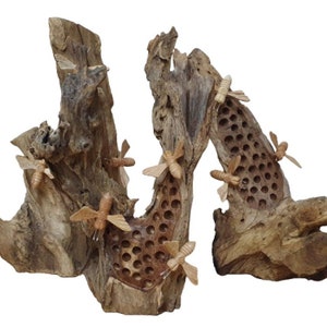 May include: A wooden sculpture of a beehive with bees carved into the wood. The sculpture is made of driftwood and has a natural, rustic look.