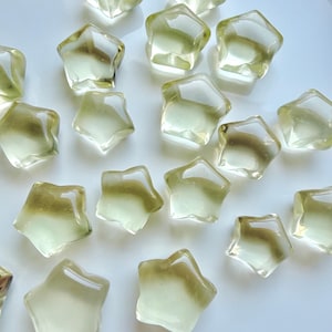 Mini Lemon Citrine stars in two sizes with clear lemon-yellow color and subtle natural crystalline patterns