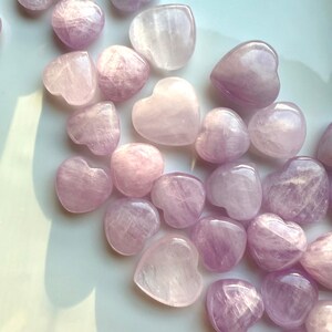 Close-up detail showing shimmer & color variations in Pink Kunzite mini hearts — radiant crystals for love & heart-centered energy.