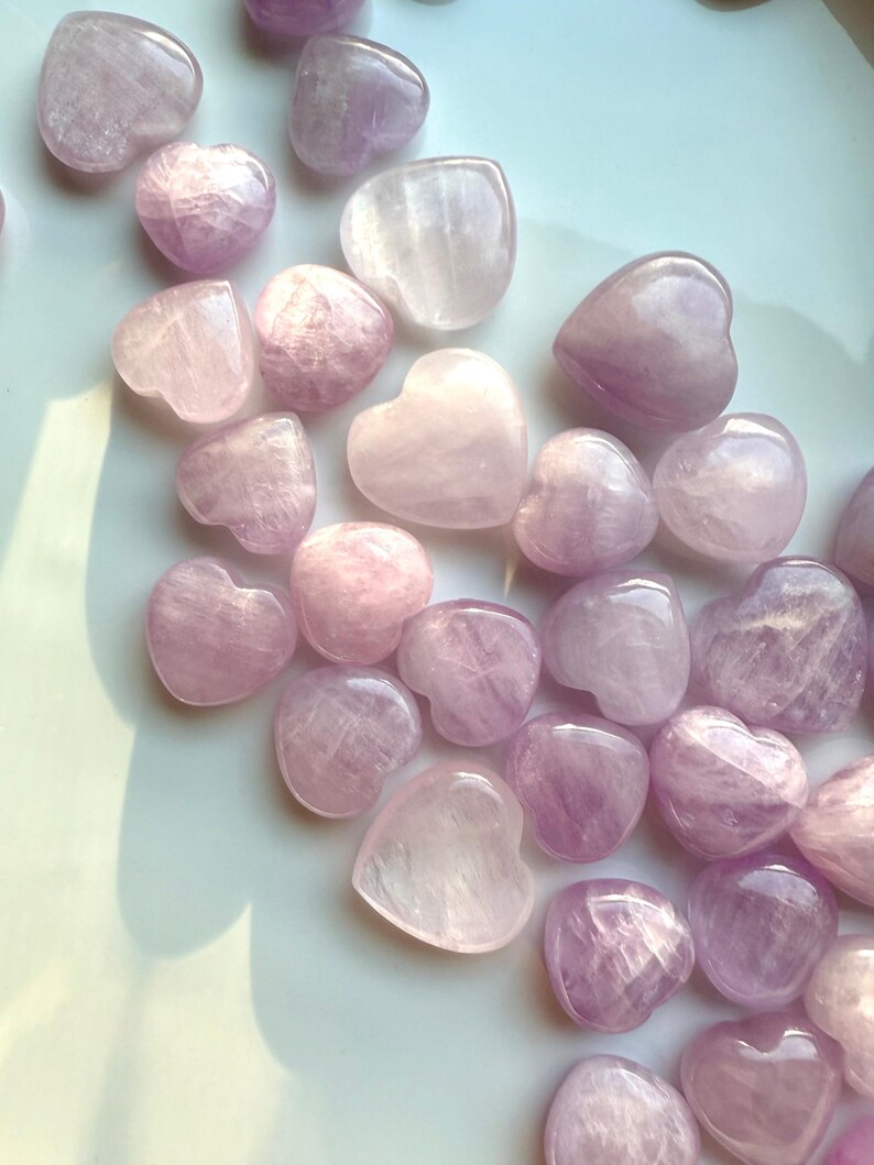 Close-up detail showing shimmer & color variations in Pink Kunzite mini hearts — radiant crystals for love & heart-centered energy.