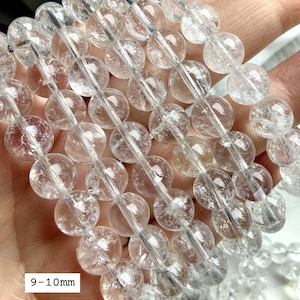 Polished Rainbow Clear Quartz crystal bracelets showing 9-10mm transparent gemstone beads in natural sunlight