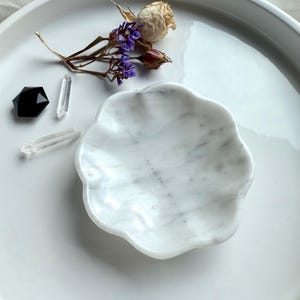 White marble daisy bowl with scalloped edges, styled empty with dried flowers and crystals