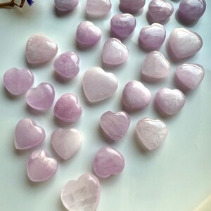 Angled view of Pink Kunzite crystal hearts on white — soothing heart chakra stones for emotional support & spiritual healing.