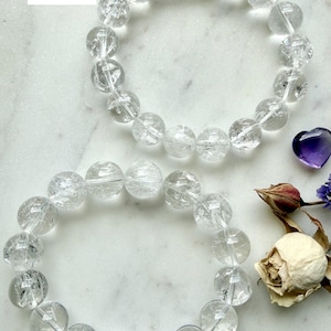 Stretchy Rainbow Quartz bracelet beside dried flowers showing bead size comparison