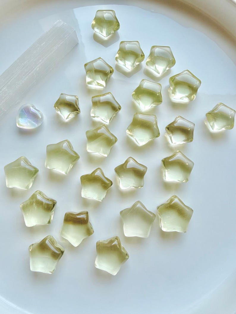 Mini Lemon Citrine stars in two sizes showing their clear, translucent lemon-yellow color