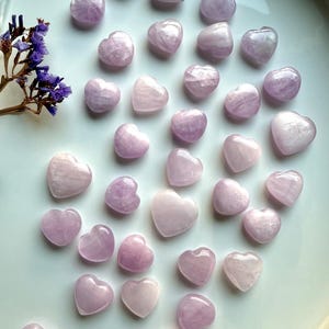 Wide shot of Pink Kunzite mini hearts on a white background — soft pink crystal hearts for love, calm & intentional energy work.