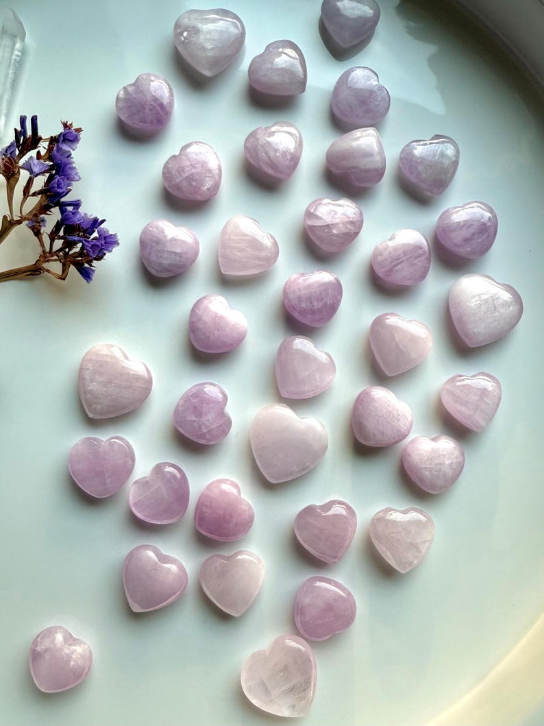 Wide shot of Pink Kunzite mini hearts on a white background — soft pink crystal hearts for love, calm & intentional energy work.