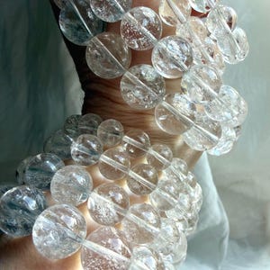 Layered Rainbow Quartz bracelets with glossy polished crystal beads and luxe stacking style