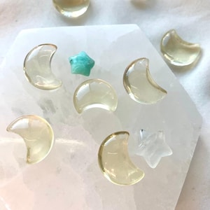 Mini Lemon Citrine moons and stars arranged on a Selenite plate with colorful celestial crystal accents