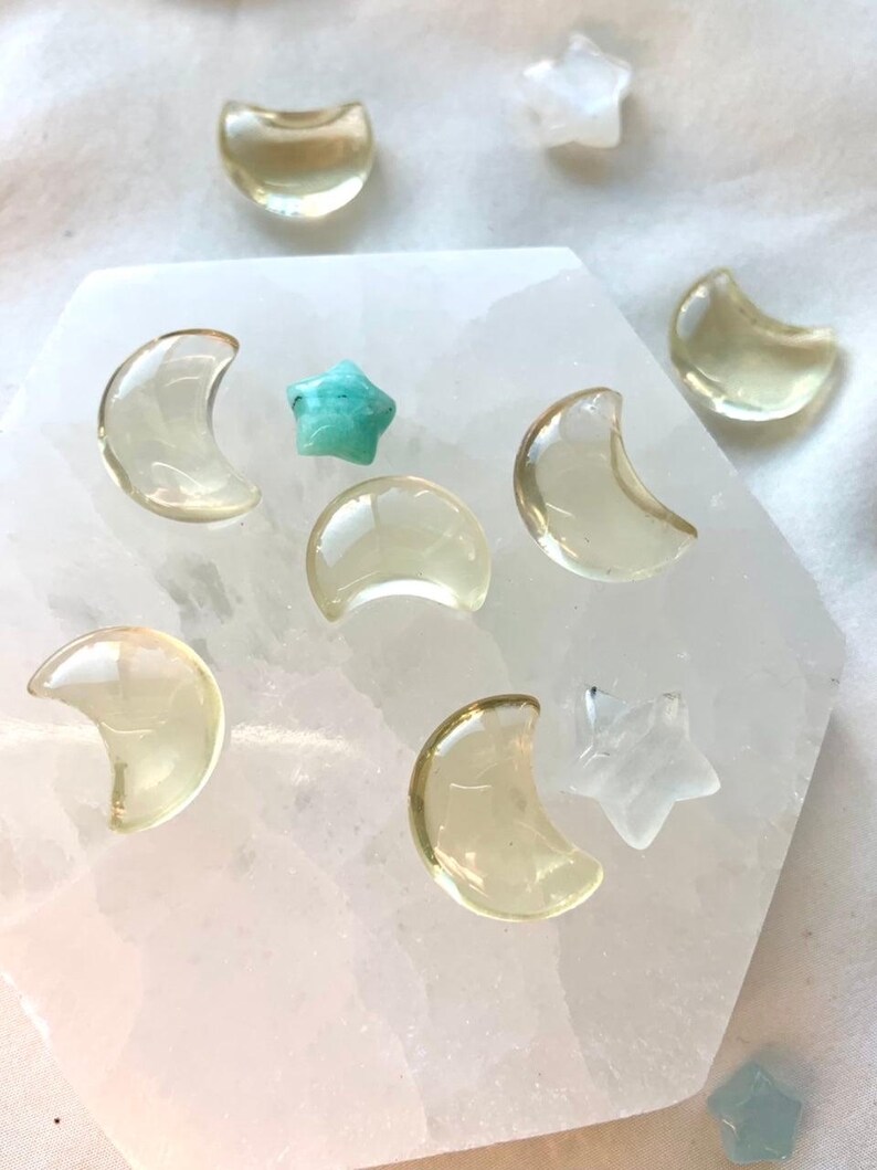 Mini Lemon Citrine moons and stars arranged on a Selenite plate with colorful celestial crystal accents