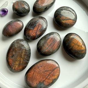 Sunset Labradorite palm stones with vibrant peach and golden flash in natural light