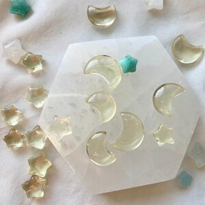 Mini Lemon Citrine moons and stars displayed with Clear Quartz points and celestial crystals on a Selenite plate