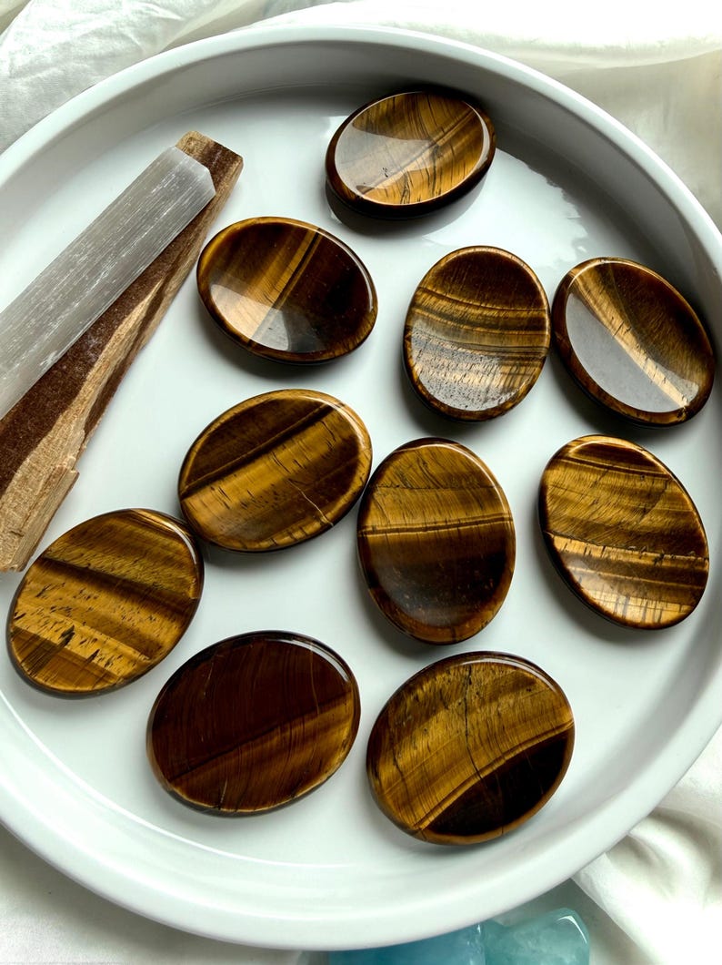 tiger’s eye oval worry stones arranged in ceramic dish, polished thumb stones for protection focus and personal power