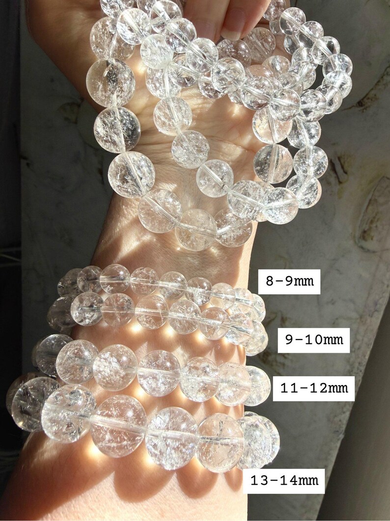 High clarity Clear Quartz bracelet stack shown bead sizes marked 8-14mm for comparison, and iridescent rainbow reflections