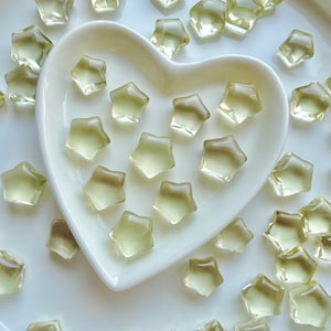 Mini Lemon Citrine stars arranged around a heart-shaped Selenite bowl filled with more golden Citrine stars