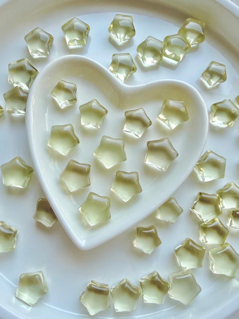 Mini Lemon Citrine stars arranged around a heart-shaped Selenite bowl filled with more golden Citrine stars