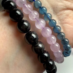Our Black Tigers Eye Bracelet worn with Devil Aquamarine + Watermelon Lilac Kunzite Bracelets