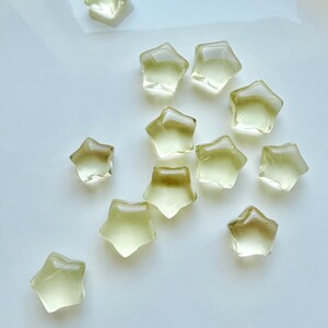 Mini Lemon Citrine stars showing translucent golden-yellow color and subtle natural crystalline patterns