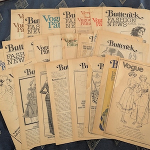 May include: A collection of vintage Butterick Fashion News and Vogue Pattern leaflets from the 1970s. These off-white paper publications feature black ink illustrations of clothing designs, fashion editorial text, and branding logos.