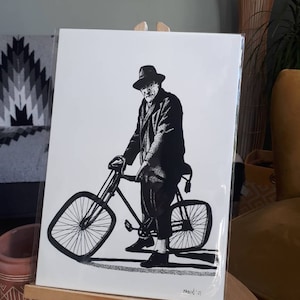 Op de afbeelding: Zwart-witte illustratie van een man met een hoed en jas op een fiets. De afbeelding is gesigneerd met "FABIN' 21".