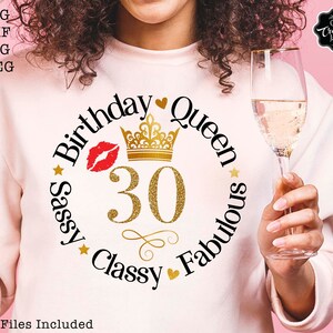 May include: A pink shirt with a black and gold design that says "Birthday Queen Sassy Classy Fabulous" with a gold crown and the number 30 in the center.