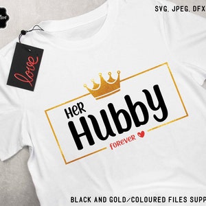 May include: White t-shirt with a gold crown and the text "Her Hubby Forever" in black with a red heart.