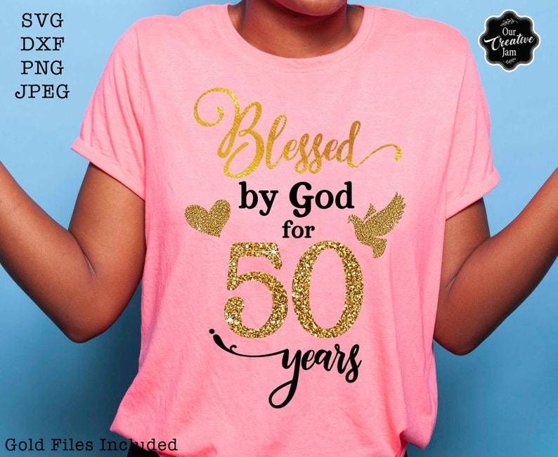 May include: Pink t-shirt with gold glitter text that reads "Blessed by God for 50 years".