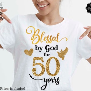 May include: A white t-shirt with a gold glitter design that says "Blessed by God for 50 years".