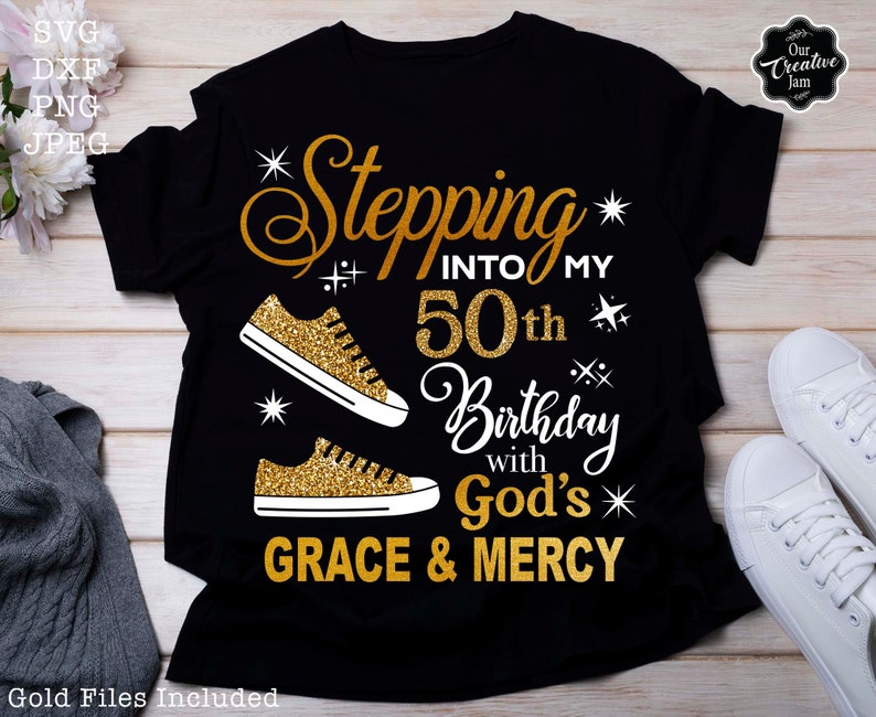 May include: Black t-shirt with gold glitter text that reads "Stepping into my 50th Birthday with God's Grace & Mercy". The text is surrounded by gold glitter stars and two gold glitter sneakers.