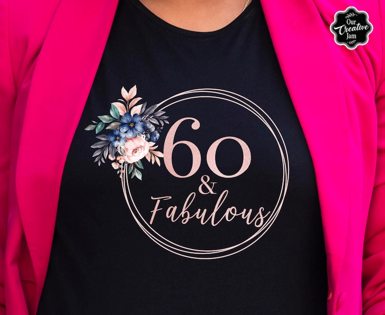 May include: Black t-shirt with a pink circle and the text "60 & Fabulous" in a pink font. The circle is decorated with a floral design in shades of blue, green, and pink.