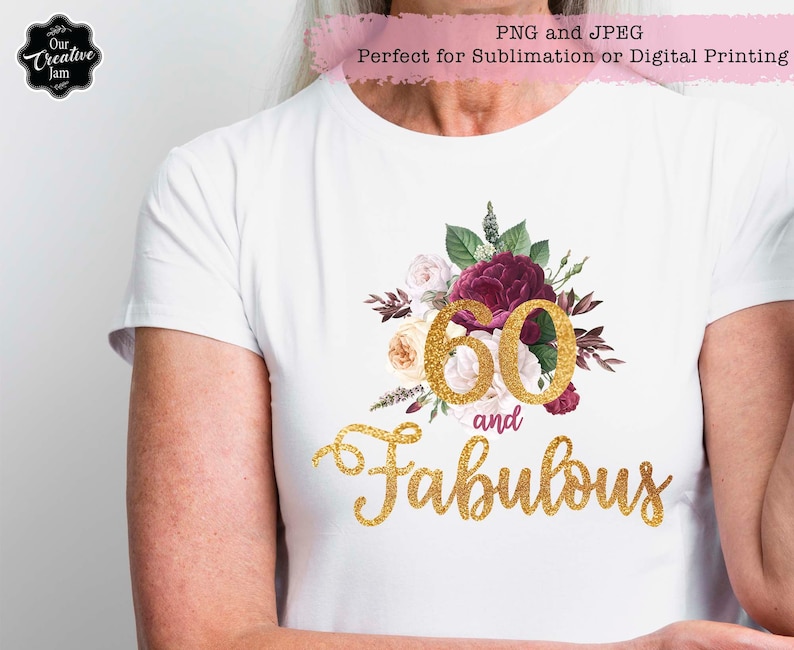 May include: White t-shirt with a gold glitter design that says "60 and Fabulous". The number 60 is surrounded by burgundy and white flowers.