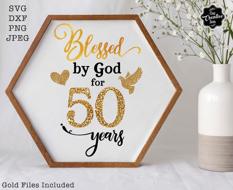 May include: A white hexagonal sign with a gold glitter design that says "Blessed by God for 50 years". The sign is framed in wood and has a gold heart and a gold dove on it.