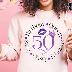 May include: A white sweatshirt with a purple glitter design that says "Sassy Birthday Queen 50 Classy Fabulous" with a crown, a heart, and a purple glitter lip print.