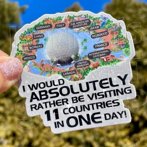 Può includere: Un adesivo bianco con un design a mappa con vari paesi e il testo "I WOULD ABSOLUTELY RATHER BE VISITING 11 COUNTRIES IN ONE DAY!". L'adesivo include il logo del negozio.