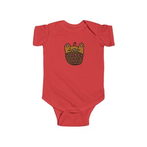 May include: Red baby bodysuit with a cartoon bear face design. The bear face is brown with pink triangles and a small swirl on top. The bodysuit is made of soft material.