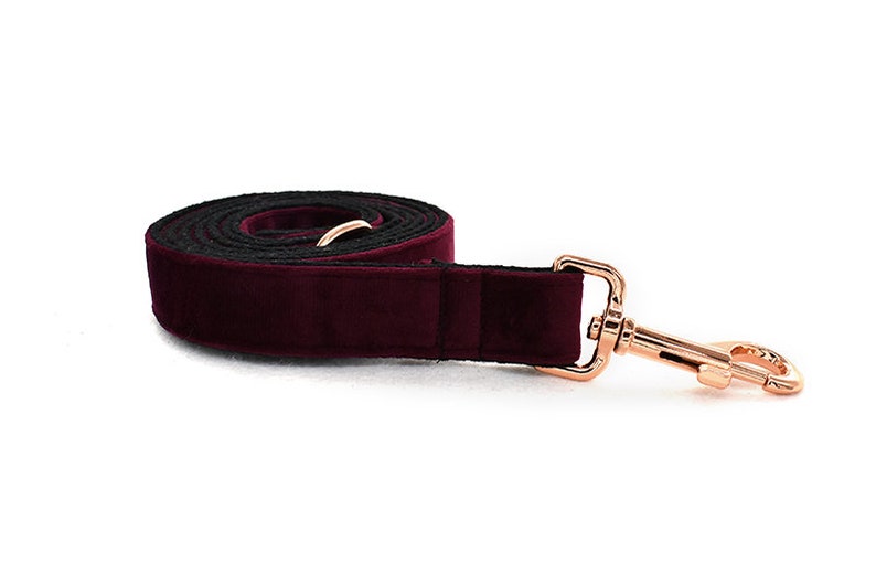 May include: Burgundy velvet dog leash with a rose gold metal clasp.