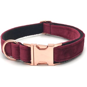 May include: A burgundy velvet dog collar with a rose gold buckle and a black nylon lining.