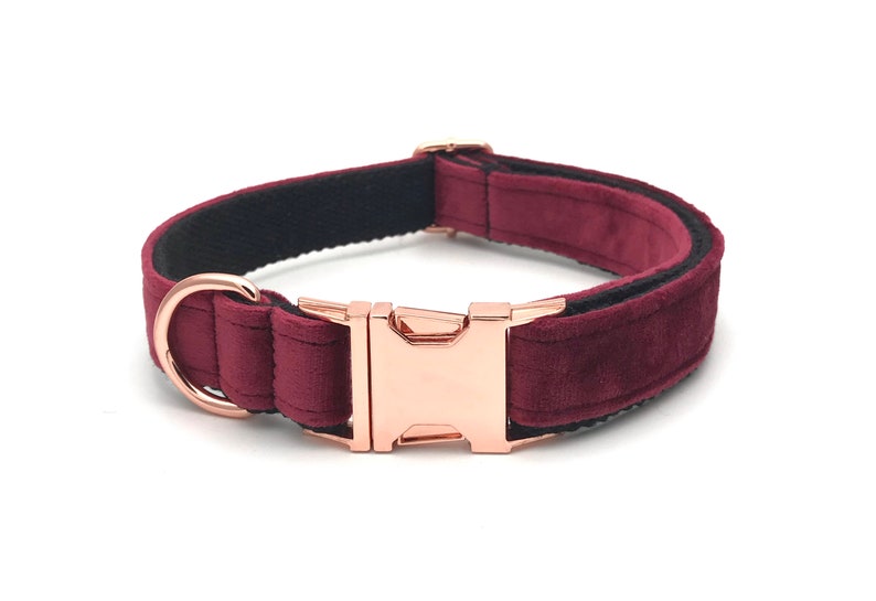 May include: A burgundy velvet dog collar with a rose gold buckle and a black nylon lining.