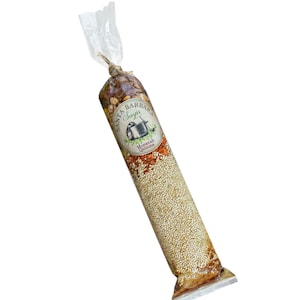 May include: A clear plastic bag filled with a Moroccan Quinoa soup mix. The bag has a label that says "Santa Barbara Soups" and "Moroccan Quinoa".