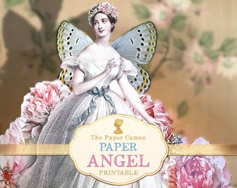 May include: A printable paper angel craft with a white dress, floral accents, and butterfly wings. The text "The Paper Cameo PAPER ANGEL PRINTABLE" is on a gold label.