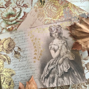 May include: A vintage style image of a woman in a dress with a floral crown. The image is printed on a paper background with handwritten text and floral patterns. The image is surrounded by autumn leaves.